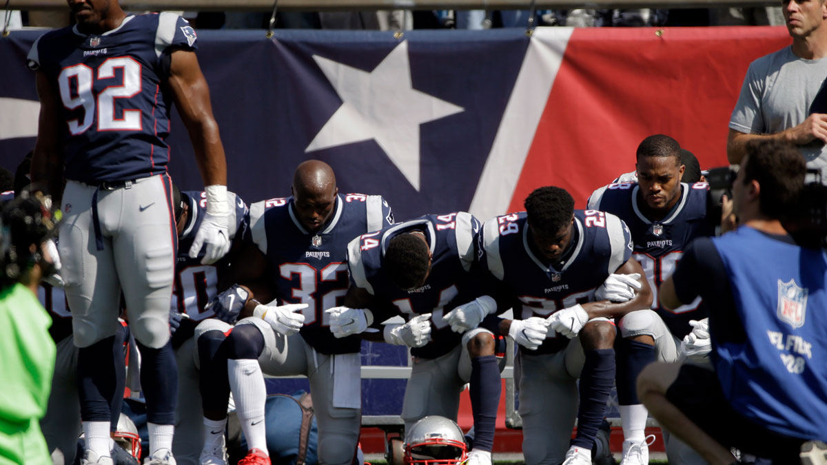 Several New England Patriots players kneel during the national anthem before an NFL football game against the Houston Texans, Sunday, Sept. 24, 2017, in Foxborough, Mass.