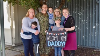 U.S. Navy Lieutenant Darren Nelson surprised his three young sons at school last week after a year-long deployment.