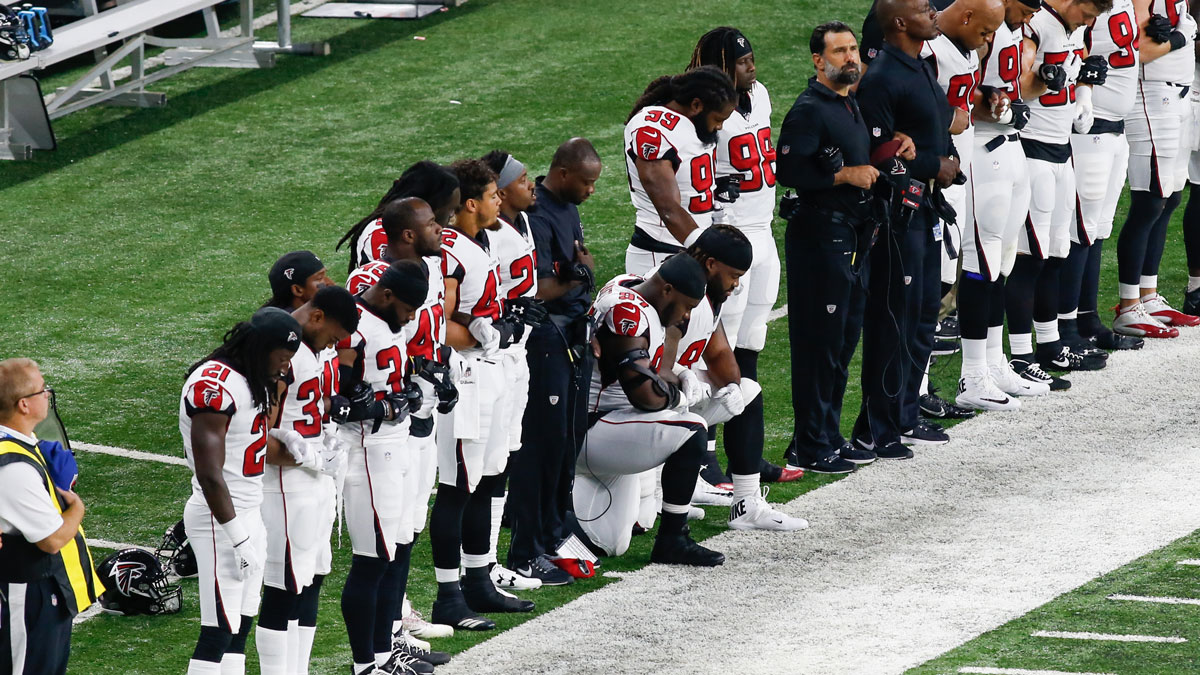 Atlanta Falcons defensive tackle Grady Jarrett (97) and Atlanta Falcons tackle Dontari Poe (92) kneel during the playing of the national anthem prior to the start of the game between the Atlanta Falcons and the Detroit Lions on Sept. 24, 2017 at Ford Field in Detroit, Michigan.