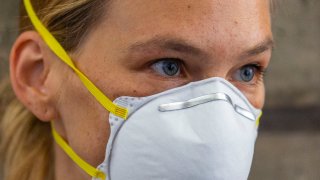 Israeli top model Bar Refaeli wears a face mask as she arrives to a court, in Tel Aviv, Israel