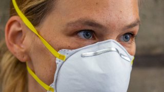 Israeli top model Bar Refaeli wears a face mask as she  arrives to a court, in Tel Aviv, Israel