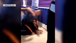 Officer seen hitting suspect on ground