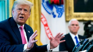 In this July 20, 2020, file photo, President Donald Trump talks to reporters with Vice President Mike Pence in the Oval Office at the White House in Washington, DC.