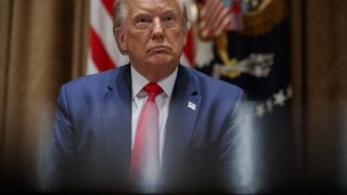 FILE - President Donald Trump listens during a meeting with U.S. tech workers, before signing an Executive Order on hiring American workers, in the Cabinet Room of the White House, Monday, Aug. 3, 2020, in Washington.