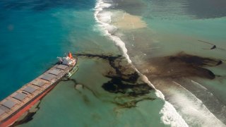 This photo provided by the French Defense Ministry shows oil leaking from the MV Wakashio, a bulk carrier ship that recently ran aground off the southeast coast of Mauritius, Sunday Aug.9, 2020