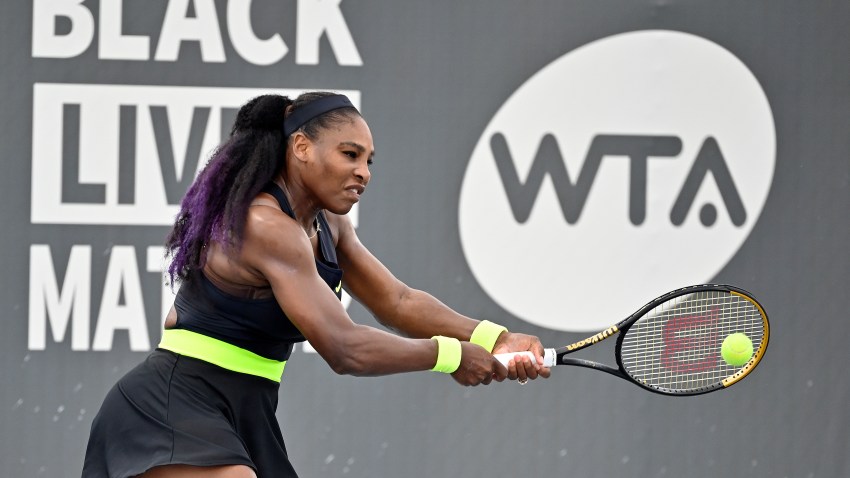 Serena Williams returns a shot to her sister Venus Williams during the WTA tennis tournament