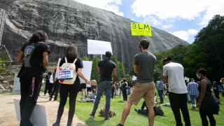 Black Lives Matter protesters gather in front of the Confederate carving in Stone Mountain Park on June 16, 2020 in Stone Mountain, Georgia. The march is to protest confederate monuments and recent police shootings.