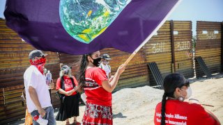 Members of the Kumeyaay band of Indians and demonstrators rally at the United States-Mexico border to protest construction of new wall on their ancestral grounds, July 1, 2020, in Boulevard, Calif.