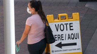 PHOENIX, AZ - AUGUST 04: A voter waits to cast their ballot during Arizona's primary election at Biltmore Fashion Park on August 4, 2020 in Phoenix, Arizona. Larger venues have been catered to allow for social distancing as adjustments are made in light of the coronavirus pandemic.