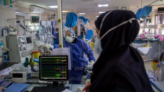 Medical personnel wearing protective suits work at a new coronavirus (COVID-19) section of the Masih Daneshvarii Hospital on August 19, 2020 in Tehran, Iran.