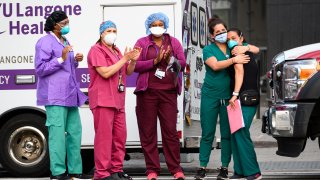 Medical workers stand outside NYU hospital