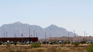 Vehicles are parked outside the La Palma Correctional Center in Eloy, Arizona