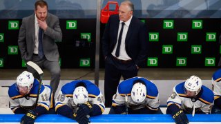 In this Aug. 21, 2020, file photo, head coach Craig Berube and the St. Louis Blues wait on the bench during the closing minutes of their loss to the Vancouver Canucks in Game Six of the Western Conference First Round during the 2020 NHL Stanley Cup Playoffs at Rogers Place in Edmonton, Alberta, Canada.