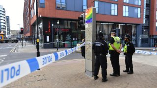 Police officers stand at a cordon in Hurst Street in Birmingham after a number of people were stabbed in the city centre, Sunday, Sept. 6, 2020. British police say that multiple people have been injured in a series of stabbings in a busy nightlife area of the central England city of Birmingham.