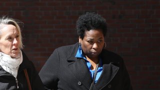 Lisa "Niki" Williams, far right, an assistant public school teacher in Houston and standardized test administrator for the College Board and ACT Inc., is pictured outside the John Joseph Moakley United State Courthouse in Boston on March 25, 2019.