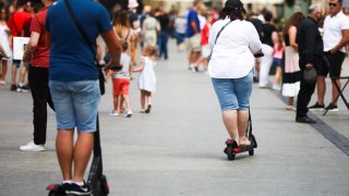 Tourists ride on electric scooters at the Main Square, popular tourist destination, during the coronavirus pandemic.