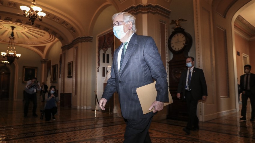 Senate Majority Leader Mitch McConnell, a Republican from Kentucky, wears a protective mask while walking to the senate floor as Amy Coney Barrett, U.S. President Donald Trump's nominee for associate justice of the U.S. Supreme Court, not pictured meets with senators at the U.S. Capitol in Washington, D.C., U.S., on Wednesday, Sept. 30, 2020. A bruising Senate confirmation fight over Trump's Supreme Court choice may seal the fates of several incumbent senators in the November election, though it has yet to drastically alter the odds for which party will control the chamber.
