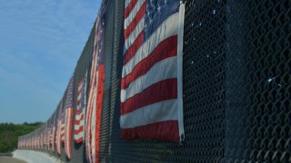 American flag on highway overpass