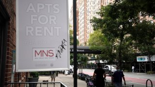 NEW YORK, NEW YORK- AUGUST 31: People walk past an apartments for rent sign in New York City.