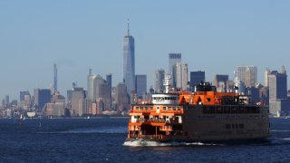 NEW YORK, NY – SEPTEMBER 4: A Staten Island Ferry sails in front of the skyline of lower Manhattan and One World Trade Center on September 4, 2020 in New York City. (Photo by Gary Hershorn/Getty Images)