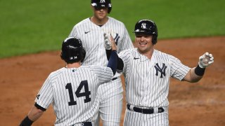 Luke Voit #59 of the New York Yankees celebrates with Tyler Wade #14 after hitting a three-run home run during the second inning against the Toronto Blue Jays at Yankee Stadium on September 15, 2020.