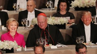 ardinal Timothy Dolan sits between, Hillary Clinton and Donald Trump