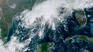 This GOES-16 GeoColor satellite image taken Saturday, Sept. 19, 2020, and provided by NOAA, shows Tropical Storm Beta, center, in the Gulf of Mexico.