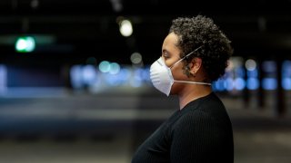 Young woman wearing a protective face mask to prevent the spread of virus in the city