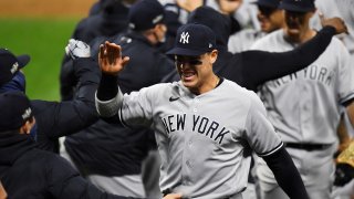 Aaron Judge #99 of the New York Yankees celebrates with teammates after the Yankees defeated the Cleveland Indians in Game 2 of the Wild Card Series between the New York Yankees and the Cleveland Indians at Progressive Field on Wednesday, September 30, 2020 in Cleveland, Ohio.