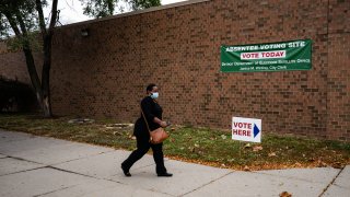 DETROIT, MI - OCTOBER 15: People make their way to cast their absentee ballot and drop it off at one of the Satellite Voting Center inside Adams-Butzel Recreational Complex during early U.S. Presidential Election voting in Detroit, Michigan on Thursday, October 15, 2020.