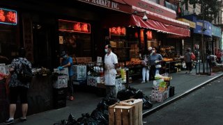 People walk past street vendors in New York City's Chinatown on August 10, 2020 in New York City.