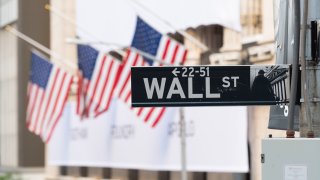 A view of the Wall Street street sign with the New York Stock Exchange as the city continues Phase 4 of re-opening following restrictions imposed to slow the spread of coronavirus on September 30, 2020 in New York City.