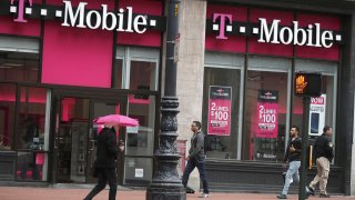 People walk by a T-Mobile store in San Francisco, California