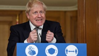 Britain's Prime Minister Boris Johnson gestures as he speaks during a press conference in 10 Downing Street, London