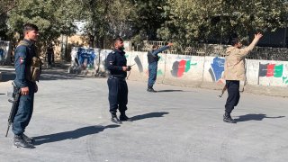 Afghan police arrive at the site of an attack at Kabul University in Kabul, Afghanistan