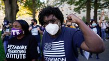 People gathered in Black Lives Matter Plaza react to the presidential race being called in Joe Biden's favor, Saturday, Nov. 7, 2020, in Washington, D.C.. Democrat Joe Biden has defeated President Donald Trump to become the 46th president of the United States.