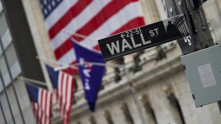 A Wall Street sign is seen nearby the New York Stock Exchange in New York