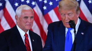 US Vice President Mike Pence (L) listens as US President Donald Trump speaks during election night in the East Room of the White House in Washington, DC, early on November 4, 2020.