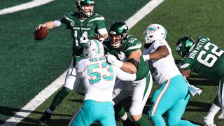 Sam Darnold #14 of the New York Jets looks to pass against the Miami Dolphins