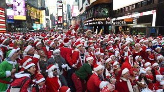 People dressed as Santa Claus and Mrs. Claus participate in SantaCon