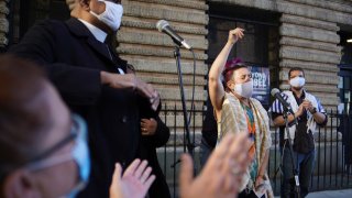 Shira Kline, a director of worship for Lab/Shul, a Jewish community-based organization, leads a group in song during an interfaith gathering outside of the Judson Memorial Church near Washington Square Park in New York, Wednesday, Nov. 4, 2020. Muslims, Jews, Christians and Buddhists came together to show solidarity among faith communities as the country awaits the final result of the U.S. presidential election.