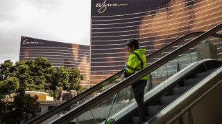 A worker cleans an escalator on Las Vegas Boulevard in Las Vegas, Nevada, U.S., on Tuesday, March 17, 2020.