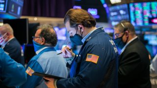 Traders work on the floor of the NYSE.