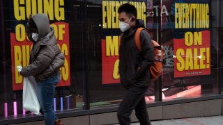 Sale signs are displayed in the window of a business in Brooklyn on December 01, 2020 in New York City.
