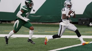 Henry Ruggs III #11 of the Las Vegas Raiders scores a touchdown to win the game