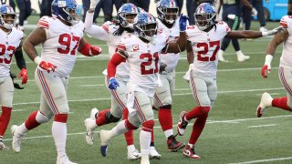 Dexter Lawrence #97, Jabrill Peppers #21 and Isaac Yiadom #27 of the New York Giants celebrate an interception