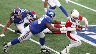 Defensive tackle Dalvin Tomlinson #94 of the New York Giants tackles quarterback Kyler Murray #1 of the Arizona Cardinals for a sack
