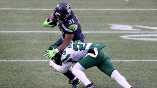 Arthur Maulet #23 of the New York Jets tackles DeeJay Dallas #31 of the Seattle Seahawks during the fourth quarter