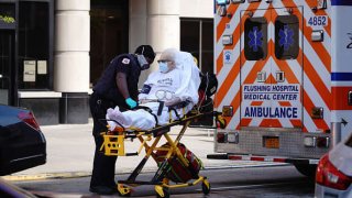 A view of a patient being wheeled out of a nursing home in Flushing Queens New York USA during coronavirus pandemic on April 22, 2020.