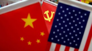 The flags of China, U.S. and the Chinese Communist Party are displayed in a flag stall at the Yiwu Wholesale Market in Yiwu, Zhejiang province, China, May 10, 2019.
